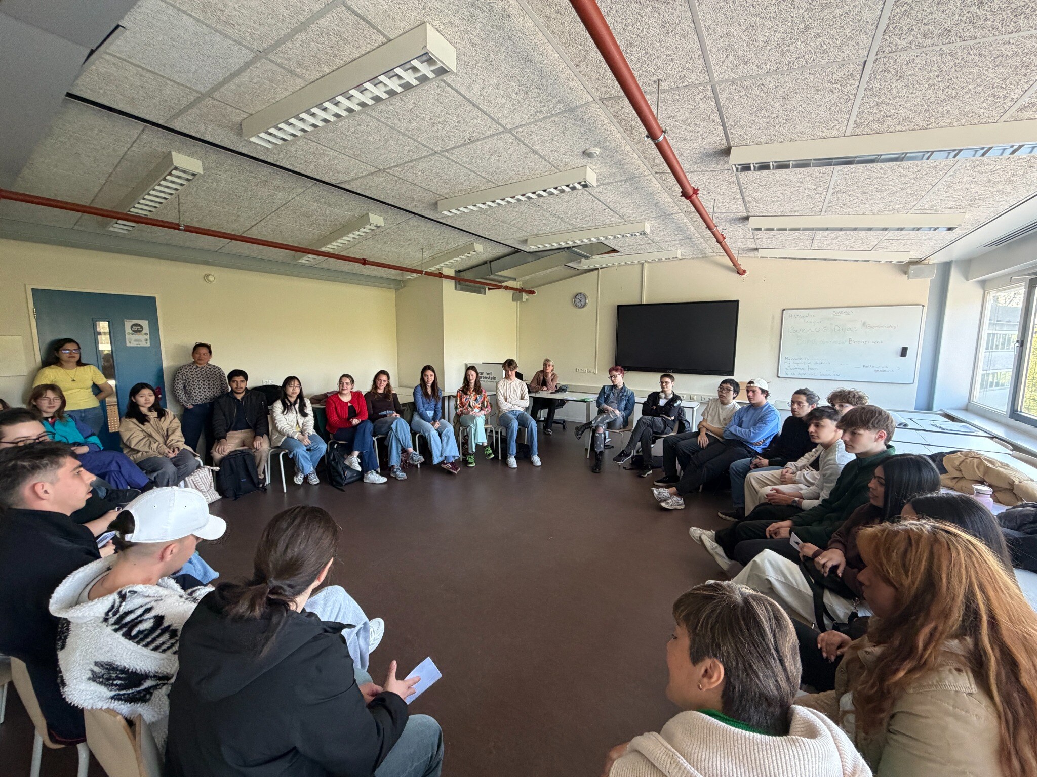 International group taking part in a classroom learning circle