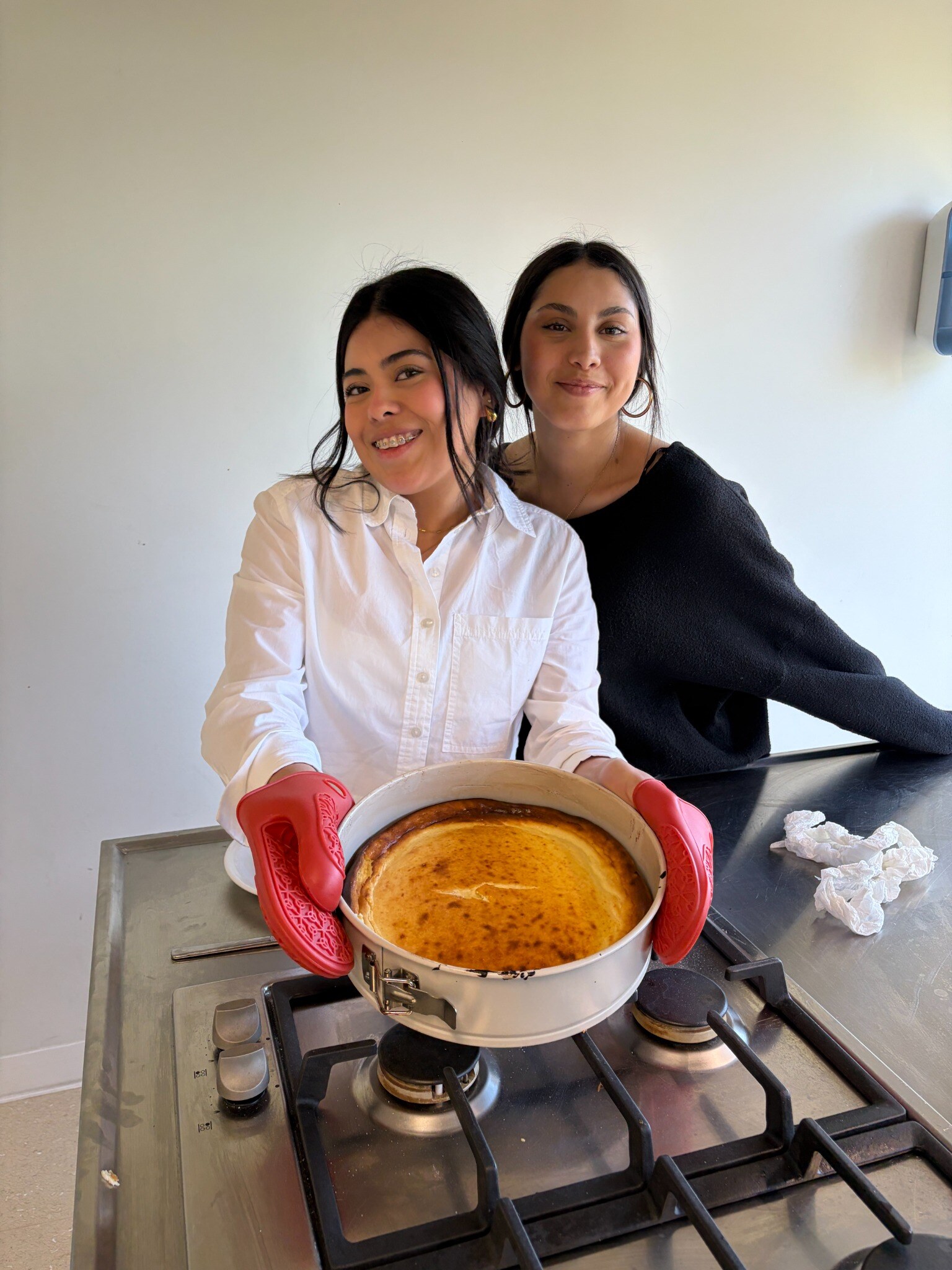 Two participants presenting a freshly baked dessert